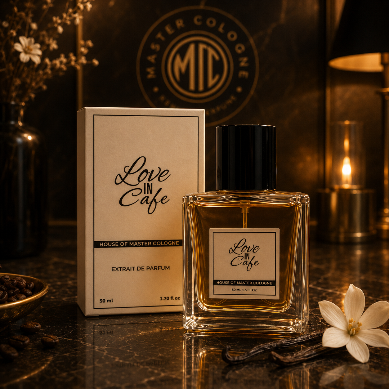 A bottle of 'Love in Cafe' extrait de parfum by House of Master Cologne sits next to its cream-colored packaging box on a dark marble surface, styled with a lit candle, vanilla bean, and white flower.